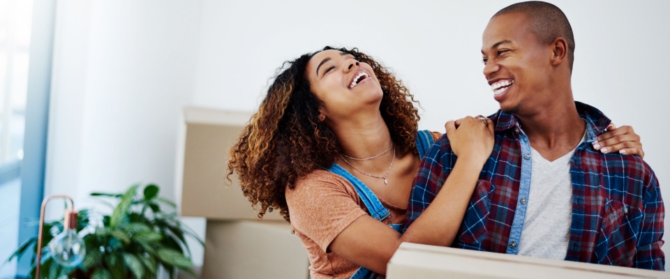 Two people moving into their rental apartment after learning the renting basics.