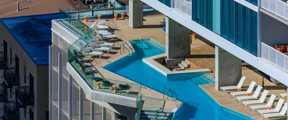 Modern rooftop pool and lounge area at downtown apartments in Austin, Texas, showcasing luxury amenities and urban living.