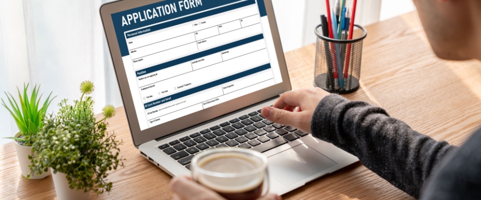 A laptop screen with an application form and empty fields to illustrate what is an online rental application?
