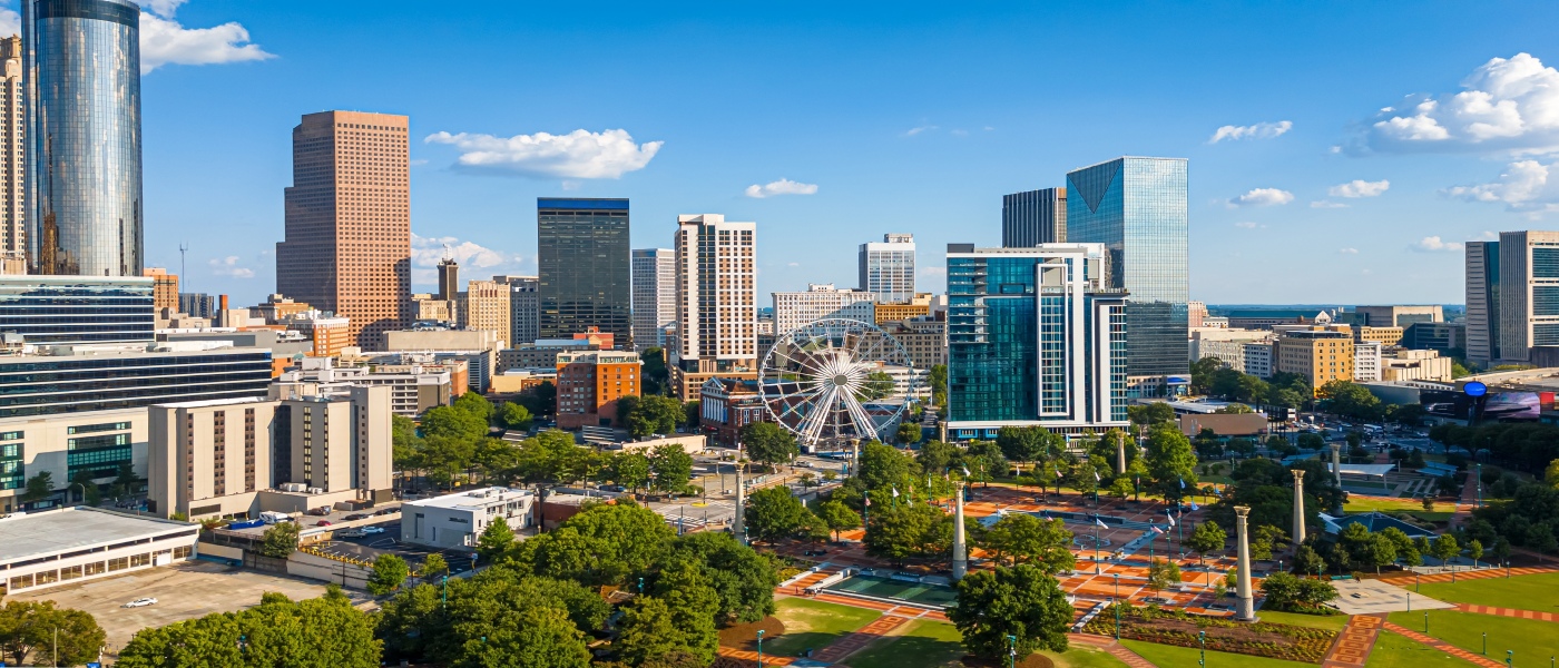 Aerial view of downtown Atlanta, Georgia, featuring skyscrapers, Centennial Olympic Park, and urban green spaces, representing market activity for a renter engagement tracker.