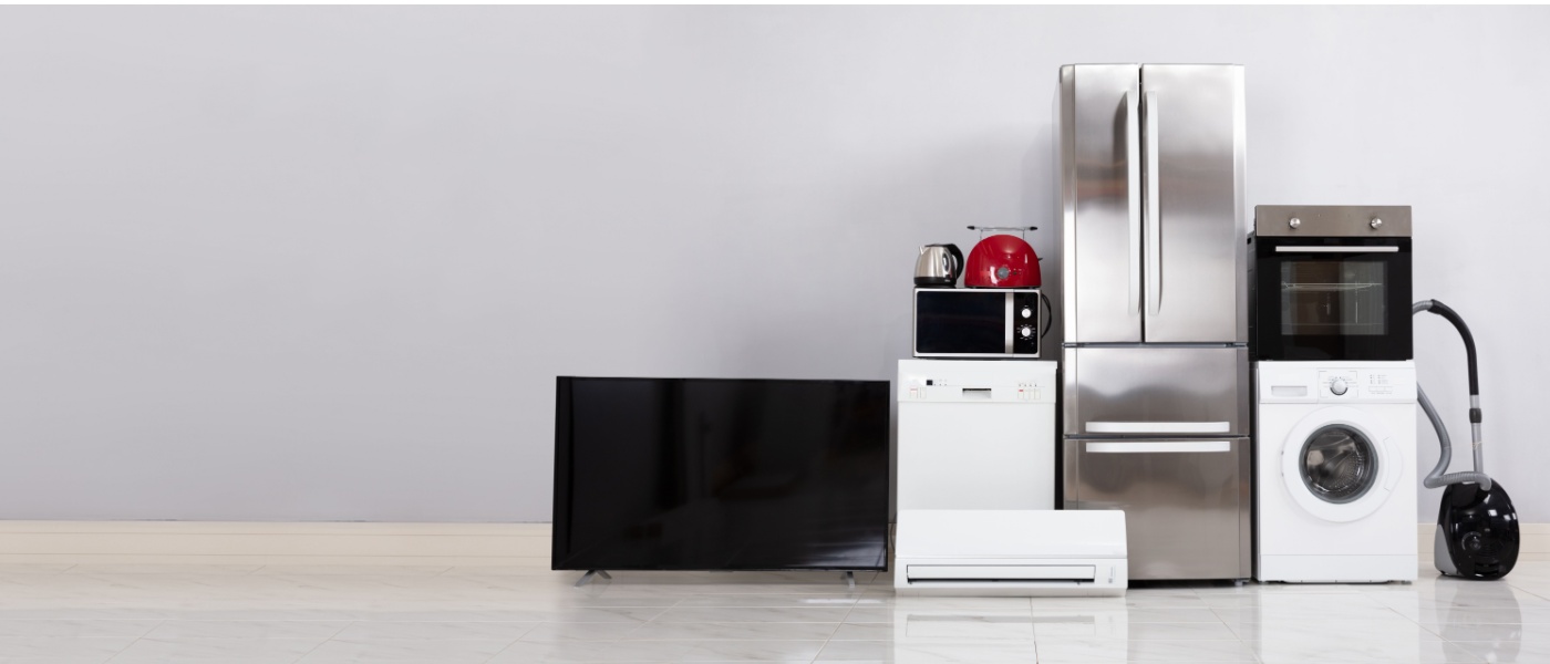 Various household appliances such as a refrigerator, washing machine, and TV that consume power even when off, illustrating common energy vampires.