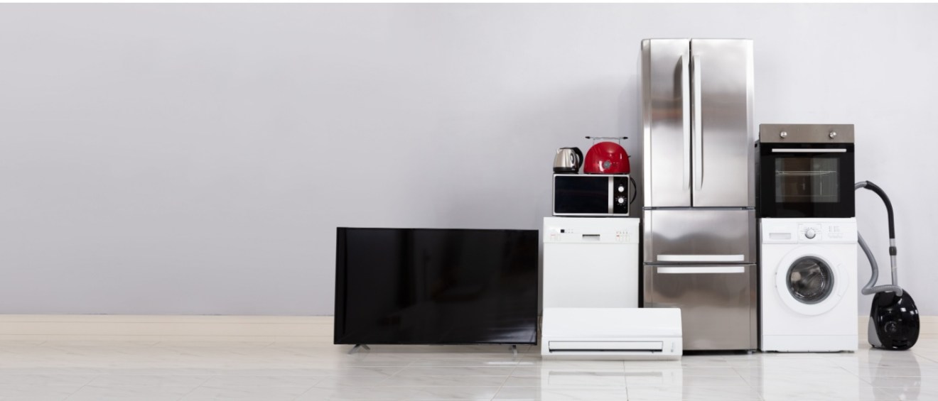 Various household appliances such as a refrigerator, washing machine, and TV that consume power even when off, illustrating common energy vampires.