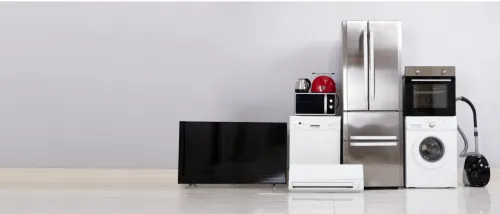 Various household appliances such as a refrigerator, washing machine, and TV that consume power even when off, illustrating common energy vampires.