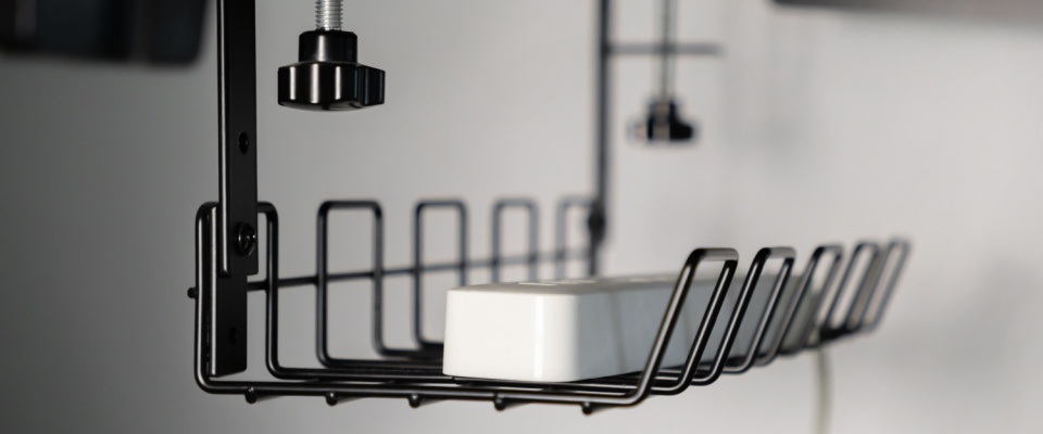 Close-up of under-desk cable management system keeping wires neat, an essential part of home office organization for a clutter-free space.