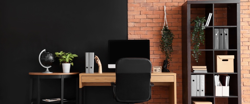 Stylish modern workspace with a tidy desk, shelves, and storage areas, showcasing effective home office organization for productivity.