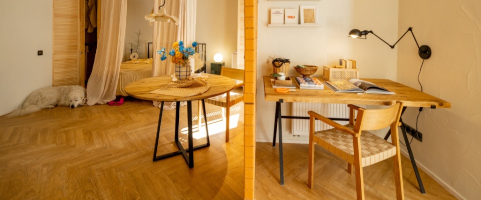 Warm, cozy apartment with two separate work areas and natural lighting, illustrating creative home office organization in small spaces.