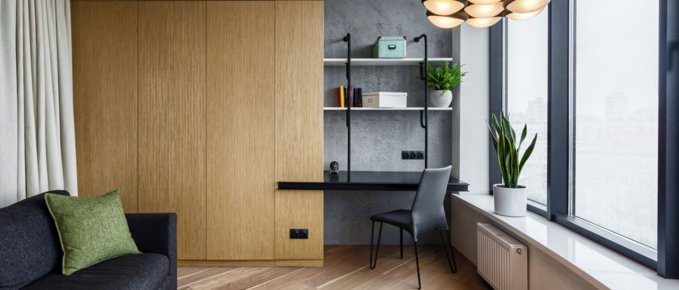 Bright modern home office with natural light, clean desk setup, and plants, demonstrating practical home office organization ideas.