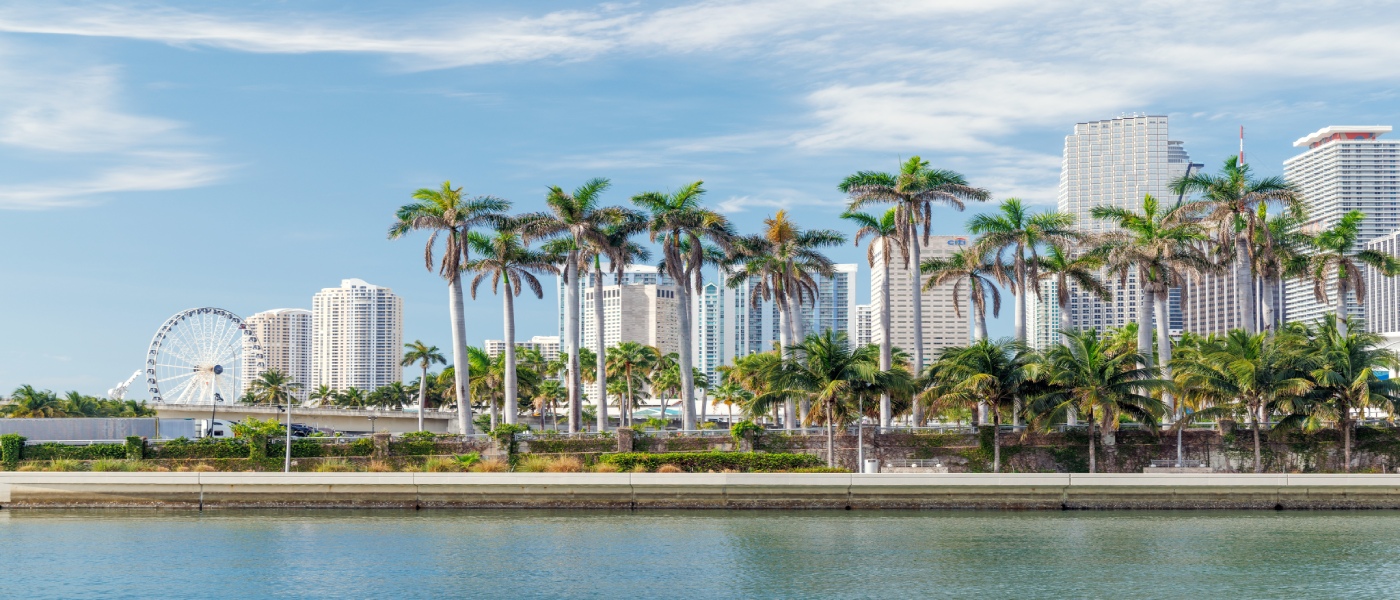 Modern Miami skyline with waterfront skyscrapers and tropical city views under a sunny sky, representing housing trends and market insights for a renter engagement tracker.