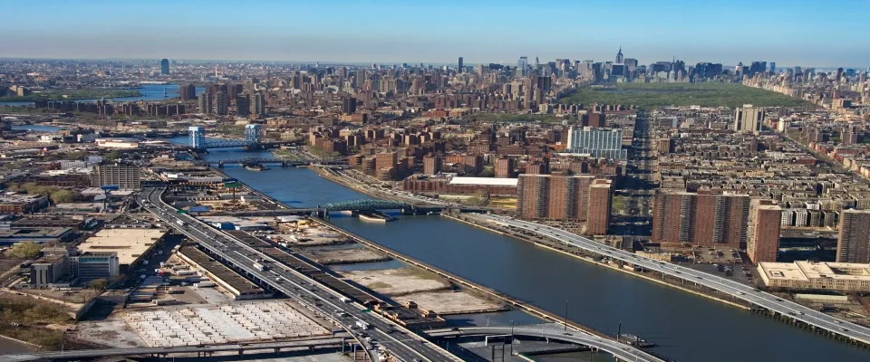 Aerial view of the Harlem River and bridges between the Bronx and Manhattan in New York City, representing urban housing activity for a renter engagement tracker.