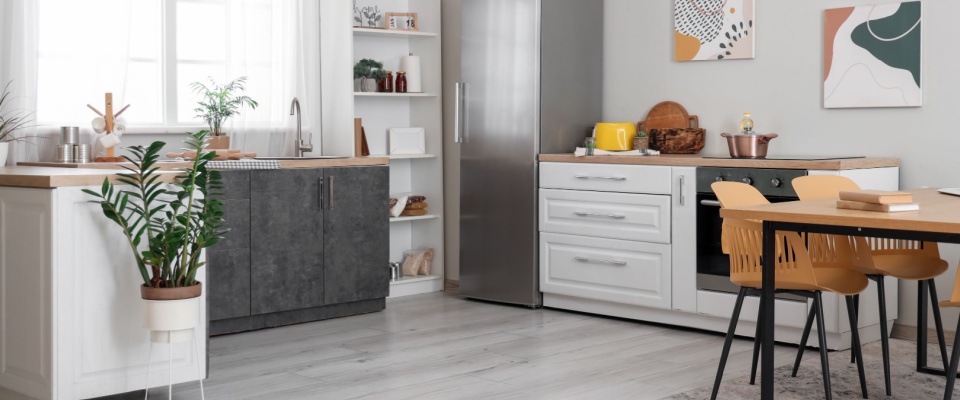 Modern kitchen interior with a dining table, refrigerator, and counter, prepared for an upcoming apartment inspection.