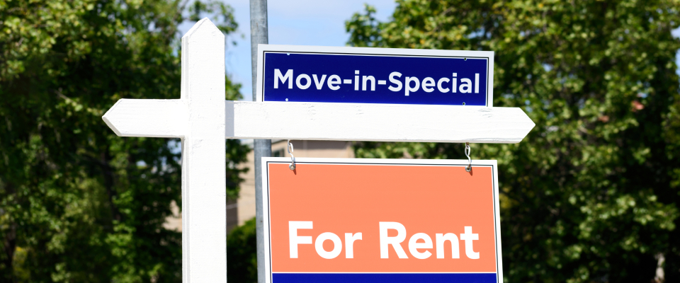 Outdoor sign showing a “Move-in Special” banner above a “For Rent” sign, indicating a rental property offering a promotional move-in deal.