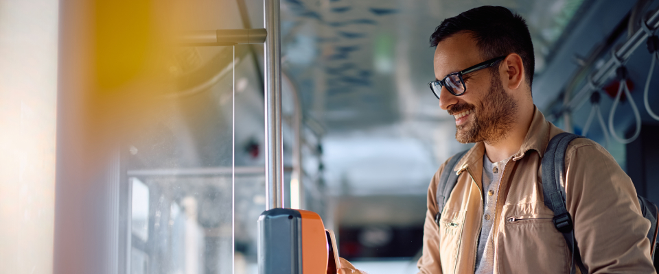 A person using their phone to pay while getting around the city via public transit.