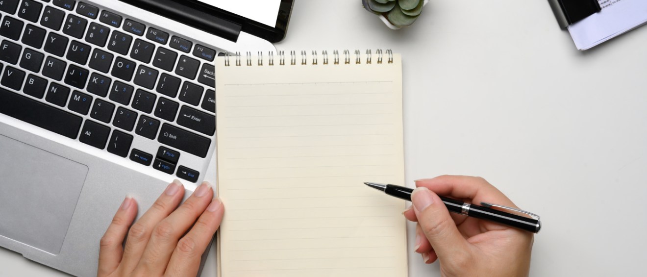 A person taking down notes on who to ask for rental references.