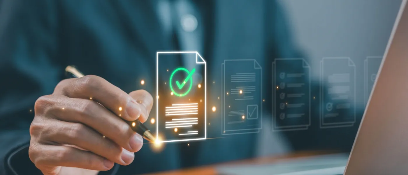 The hand of a man holding a pen and creating the check sign on a hologram to illustrate what is a verified listing.