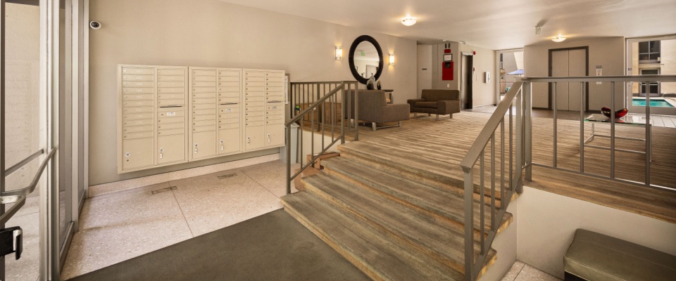 Updated apartment lobby with new flooring, paint, and mailboxes, showcasing the improved amenities after an apartment building renovation.