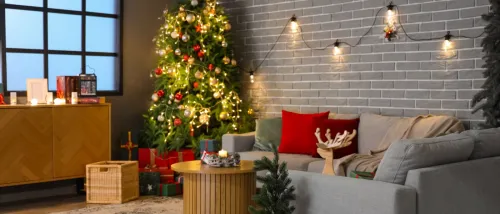 Cozy living room decorated with a Christmas tree, string lights, and candles, highlighting holiday safety tips for safe and festive home décor.