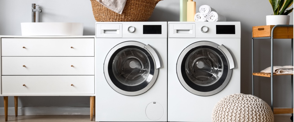 Front-loading washer and dryer in a modern laundry room, illustrating essential appliance maintenance needed to keep laundry machines running efficiently.