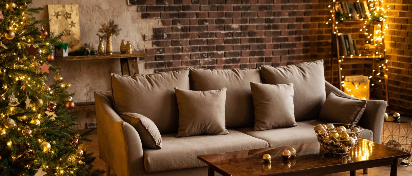 Cozy loft-style apartment decorated for Christmas, featuring a large tree, sofa, and coffee table, evoking the warmth and inspiration of an apartment hunt.