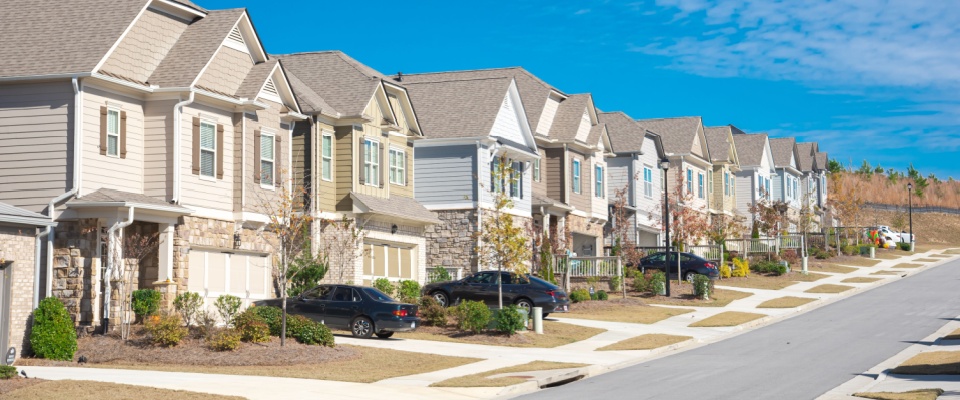 Suburban neighborhood with newly built two-story homes and tidy landscaping, used to illustrate housing options when comparing them to apartments in Tampa.