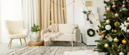 Cozy modern living room decorated for Christmas, featuring a fir tree, wrapped gifts, and holiday toys.