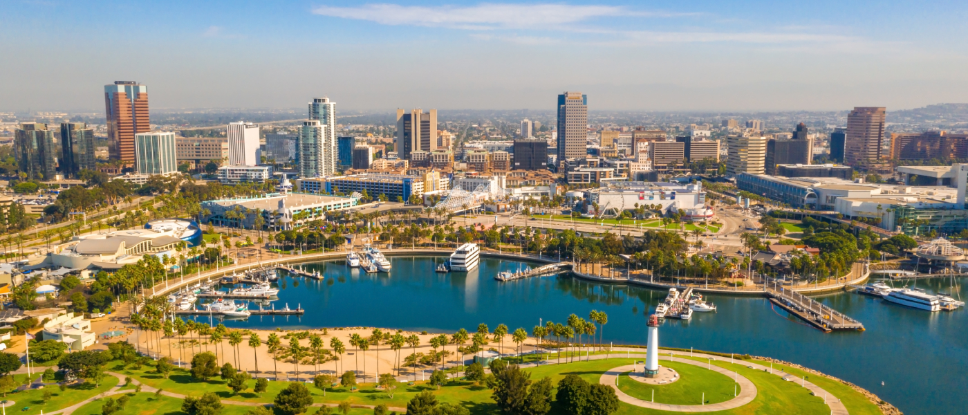 Aerial view of Long Beach, California showing the downtown skyline, marina, waterfront park, and lighthouse. Explore the five key question to ask before renting an apartment in Long Beach.