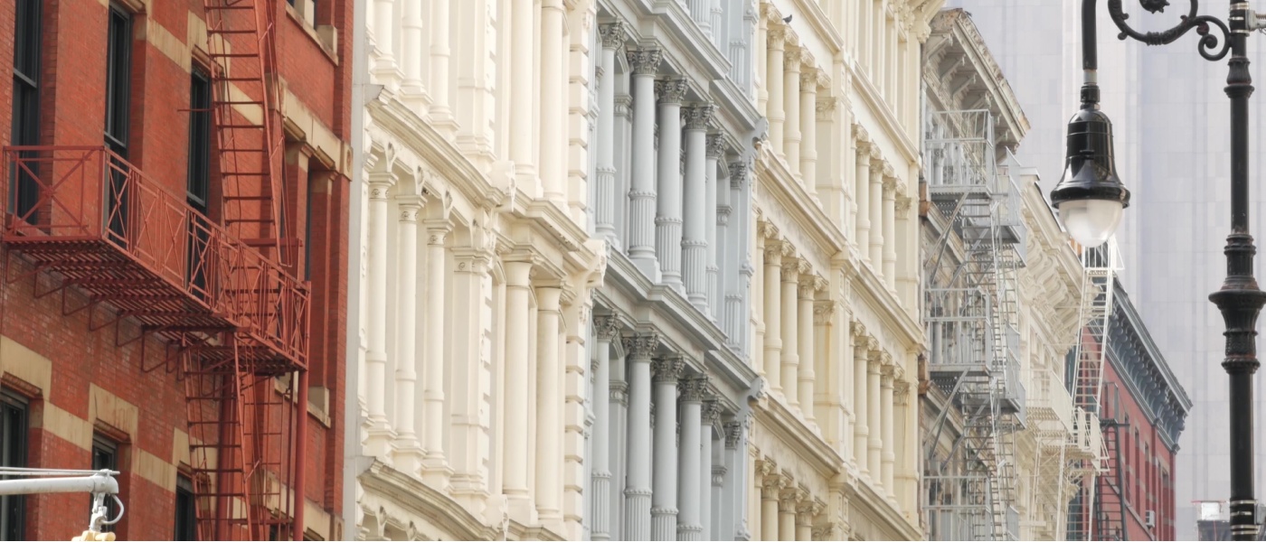 Historic property buildings in Manhattan’s SoHo district near Broadway, featuring classic New York architecture with cast-iron facades, blending residential and commercial real estate in a well-known historic neighborhood.