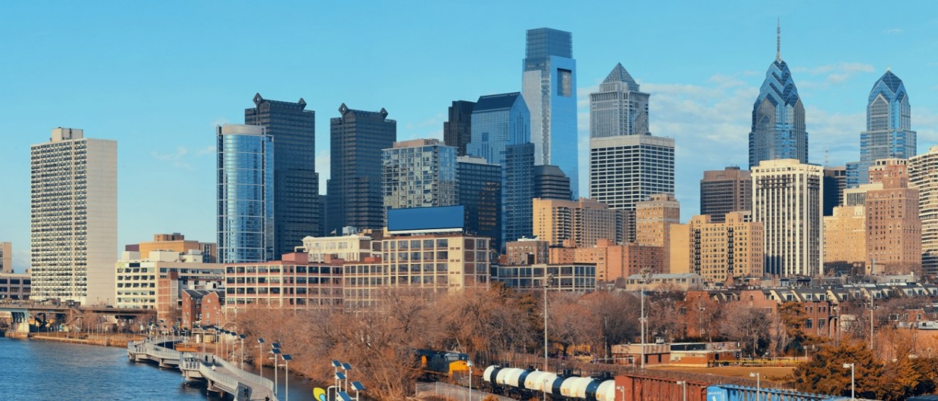 New apartments in Philadelphia highlighted by the city skyline, featuring modern urban architecture and recognizable downtown buildings.