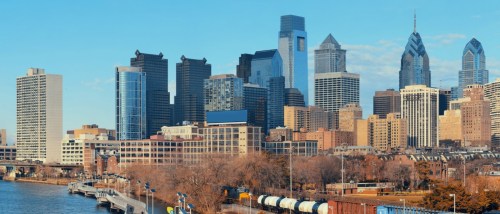New apartments in Philadelphia highlighted by the city skyline, featuring modern urban architecture and recognizable downtown buildings.