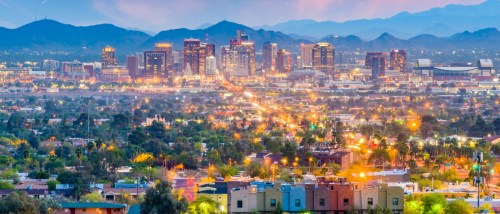 New apartments in Phoenix highlighted by a twilight view of the city skyline, with modern buildings set against the desert sky in downtown Phoenix, Arizona.