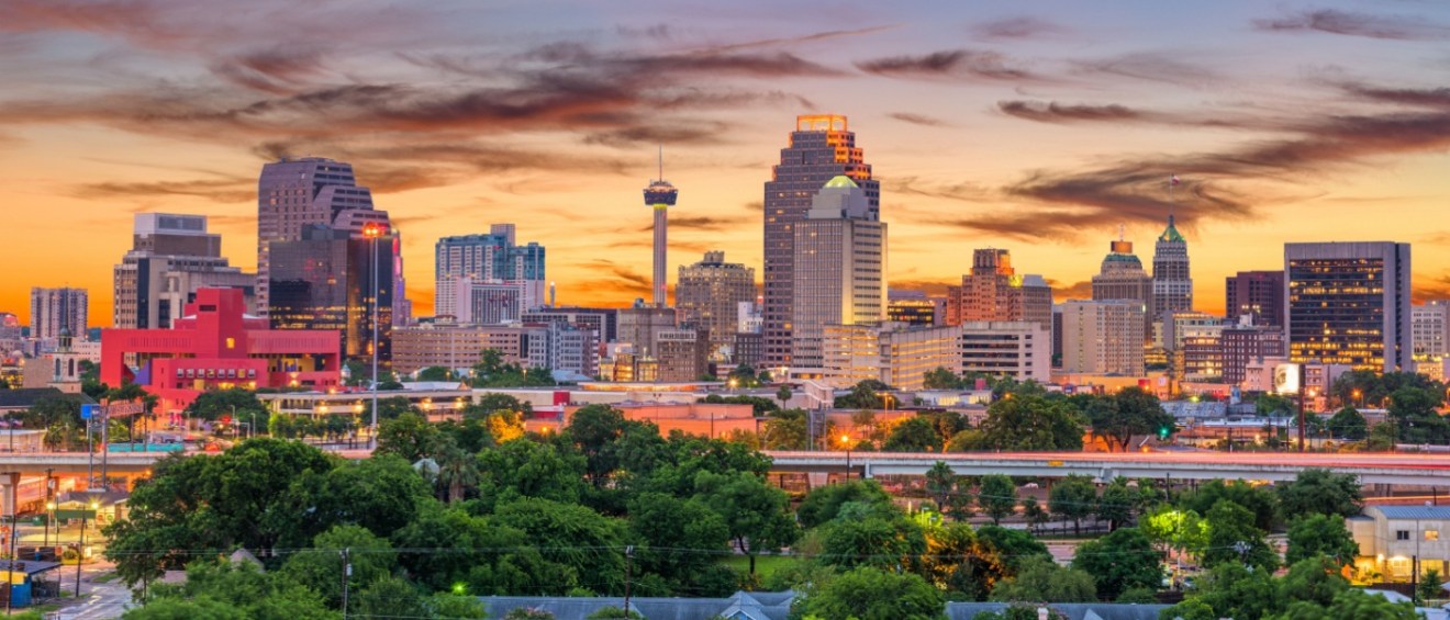 New apartments in San Antonio showcased by a view of the downtown San Antonio skyline, featuring modern buildings in the city center.