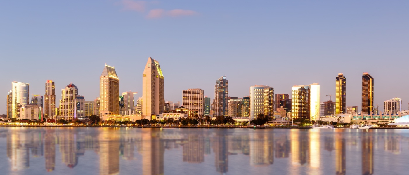 New apartments in San Diego highlighted by the downtown San Diego skyline along the waterfront, showcasing modern high-rise buildings and coastal city living.