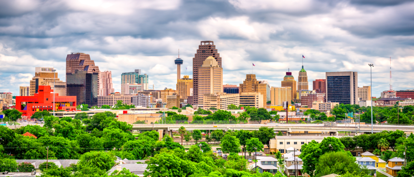 San Antonio, TX skyline with downtown high-rises, highways, and surrounding neighborhoods—highlighting the urban layout renters should consider when asking key questions before renting an apartment in San Antonio.