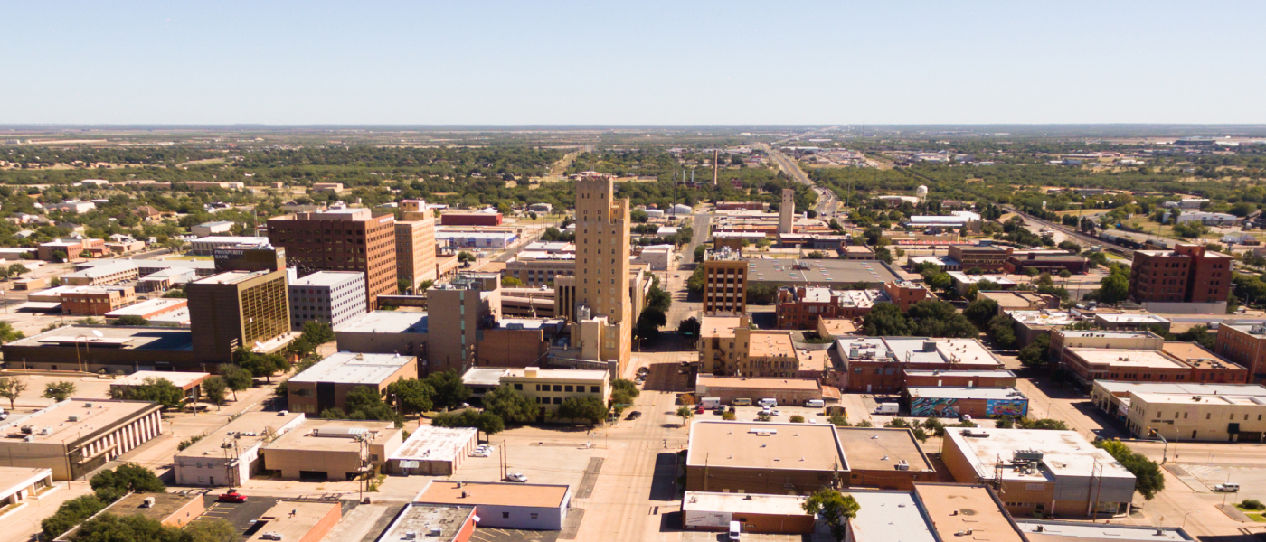 Bird’s-eye view of Lubbock, Texas, featuring mixed-use buildings and residential areas that underscore the importance of asking the right questions when renting locally.
