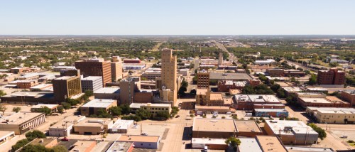 Bird’s-eye view of Lubbock, Texas, featuring mixed-use buildings and residential areas that underscore the importance of asking the right questions when renting locally.