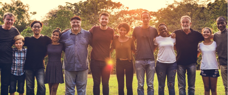 Diverse group of neighbors standing together outdoors, representing how smart home devices can support safer, more connected communities.