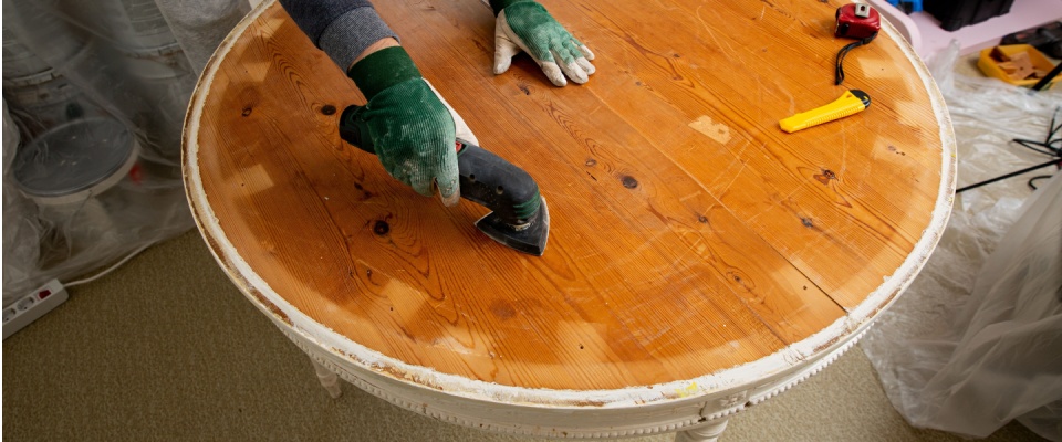 Refinishing a vintage wooden table to transform it into durable upcycled furniture for a modern home.
