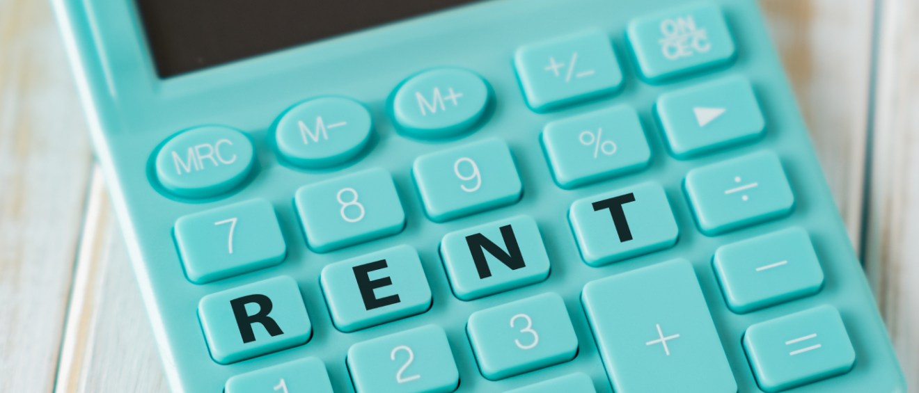 Teal calculator with the word “RENT” spelled across the number keys, symbolizing how to budget for an apartment and rent affordability planning.