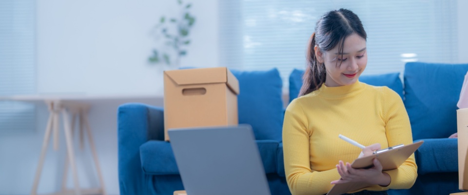 A person using their inventory checklist when moving.