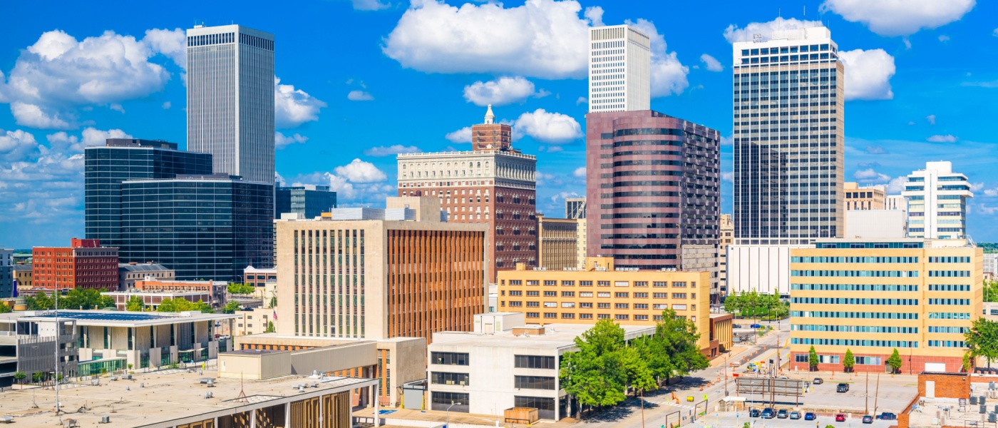 New apartments in Tulsa highlighted by the downtown skyline in the afternoon, showcasing city buildings and the urban core in daylight.