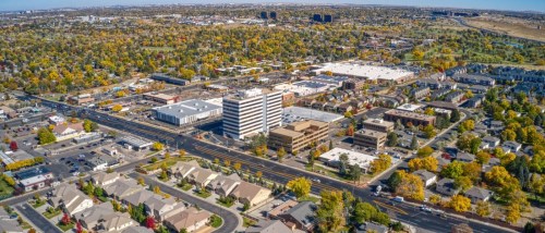 New apartments in Aurora highlighted by an aerial autumn view of the city with colorful foliage and the surrounding Colorado landscape.