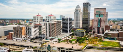 New apartments in Louisville highlighted by an aerial view of downtown Louisville from the Ohio River, showcasing the city’s skyline and waterfront setting.