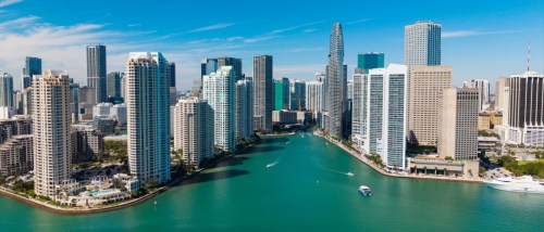 New apartments in Miami highlighted by the Brickell skyline with modern skyscrapers and waterfront city views from Brickell Key, Florida.