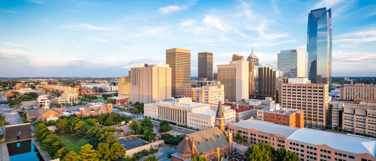 New apartments in Oklahoma City showcased by the downtown Oklahoma City skyline in the afternoon, featuring modern buildings and urban architecture.