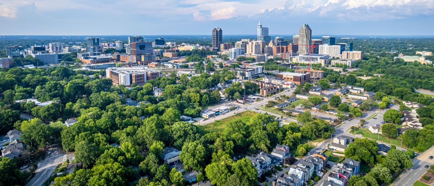 New apartments in Raleigh highlighted by a clear view of the downtown skyline against a bright blue sky in Raleigh, North Carolina.