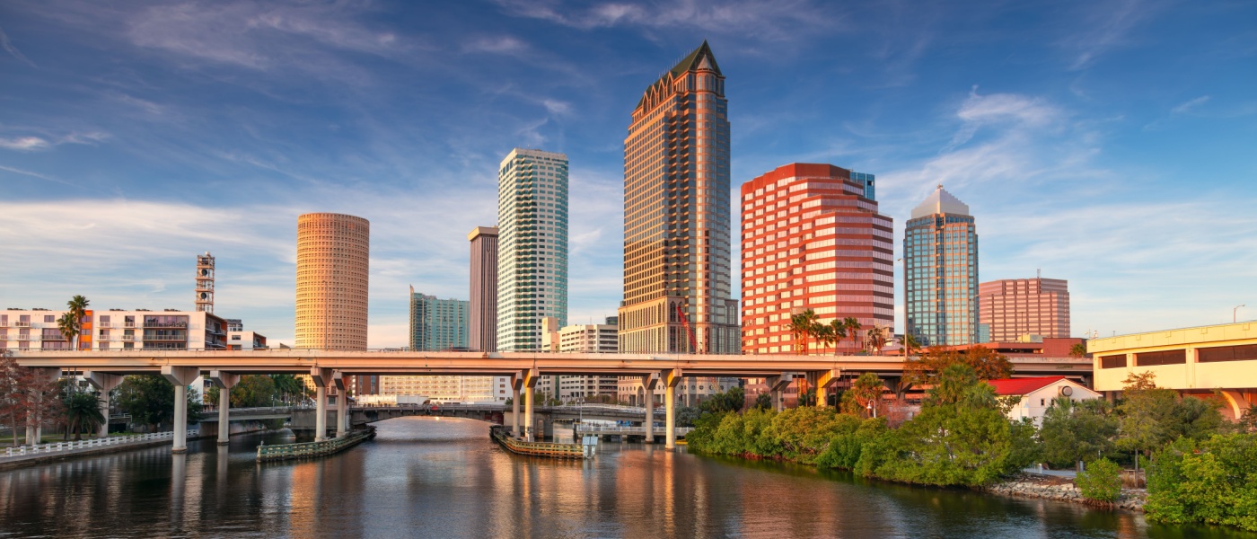 New apartments in Tampa highlighted by an aerial sunset view of the Tampa, Florida skyline with warm evening light over the city.