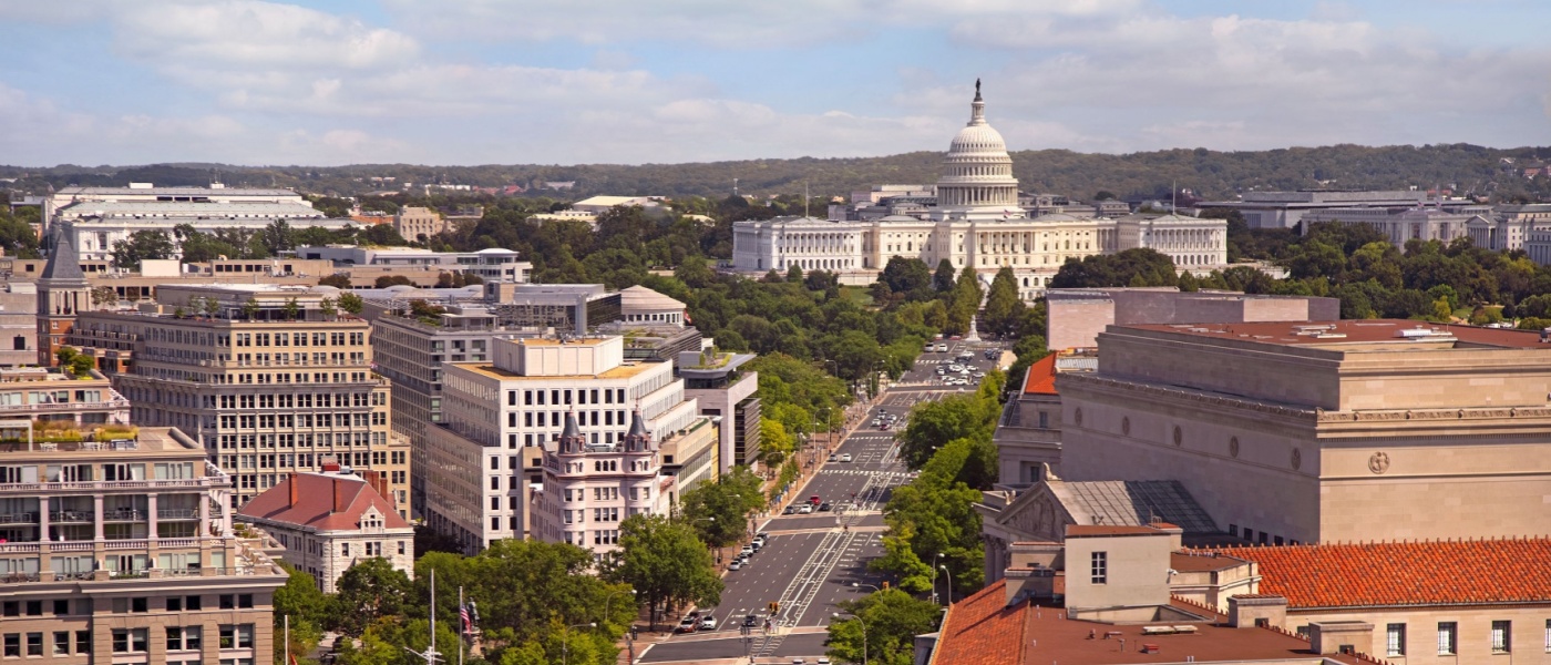 New apartments in Washington, D.C. highlighted by a sunny view of the skyline along Pennsylvania Avenue with the U.S. Capitol in the background.