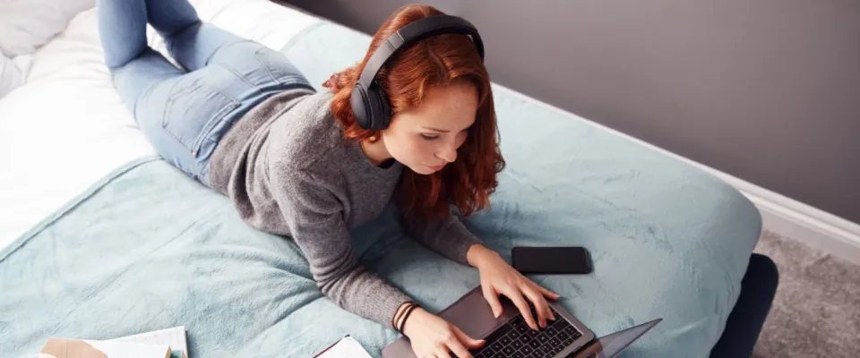 A college student uses a laptop to look at off-campus housing options.