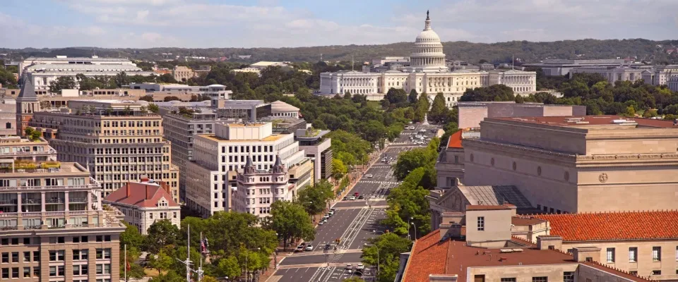 Sunny view of the Washington, D.C. skyline along Pennsylvania Avenue with the U.S. Capitol, representing one of the top cities to watch for historic charm and urban opportunity.