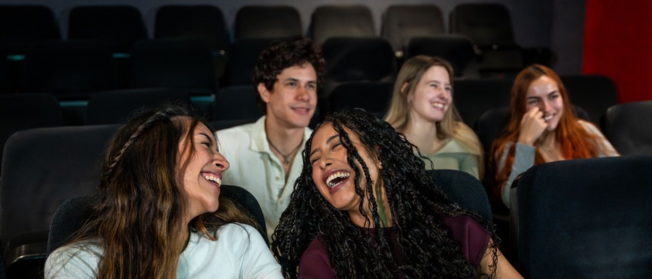 People enjoying a movie in an apartment media room.