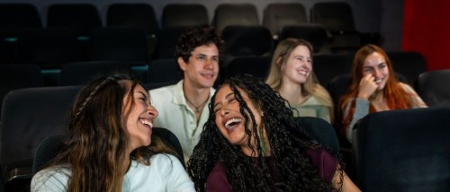 People enjoying a movie in an apartment media room.